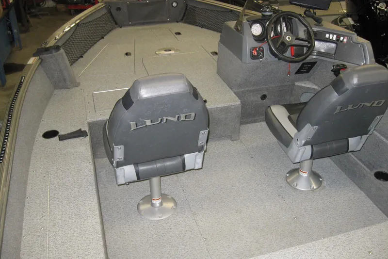 Slide: The Image of 2016 Lund 1775 Impact SS boat interior with steering console and seating. - 5