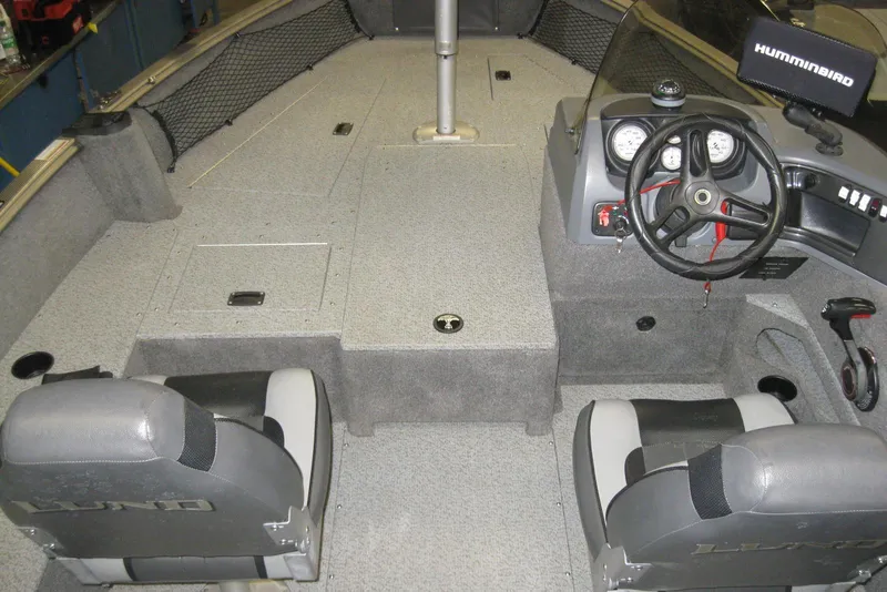 Slide: The Image of 2016 Lund 1775 Impact SS boat interior with steering wheel and seating. - 9