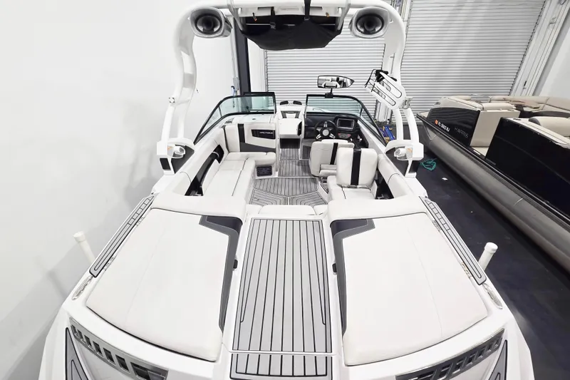 Slide: The Image of 2014 Nautique Super Air Nautique 210 boat interior with sleek seating and modern design. - 25