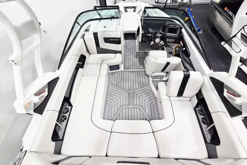 Slide: The Image of 2014 Nautique Super Air Nautique 210 interior with sleek seating and modern dashboard. - 26