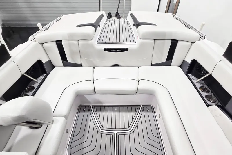 Slide: The Image of 2014 Nautique Super Air Nautique 210 boat interior with white seating and sleek design. - 29