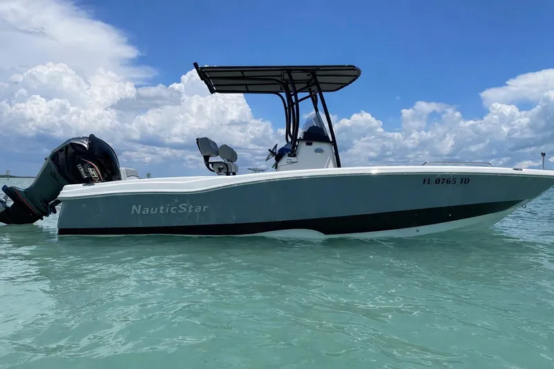 The Image of 2022 NauticStar 231 Hybrid boat on clear water under a blue sky. - 0