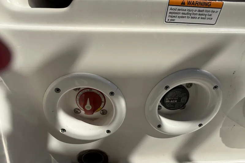 Slide: The Image of 2022 NauticStar 231 Hybrid boat control panel with warning label and switches. - 11