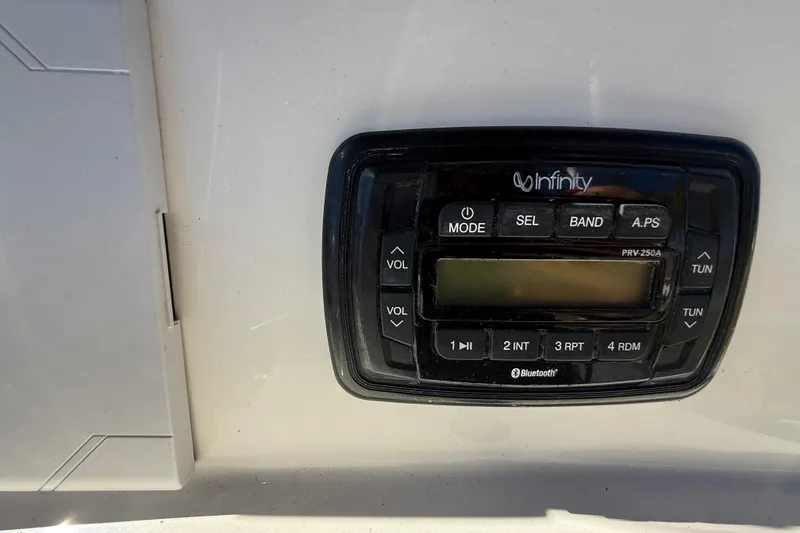 Slide: The Image of Infinity audio system on 2022 NauticStar 231 Hybrid boat dashboard. - 19