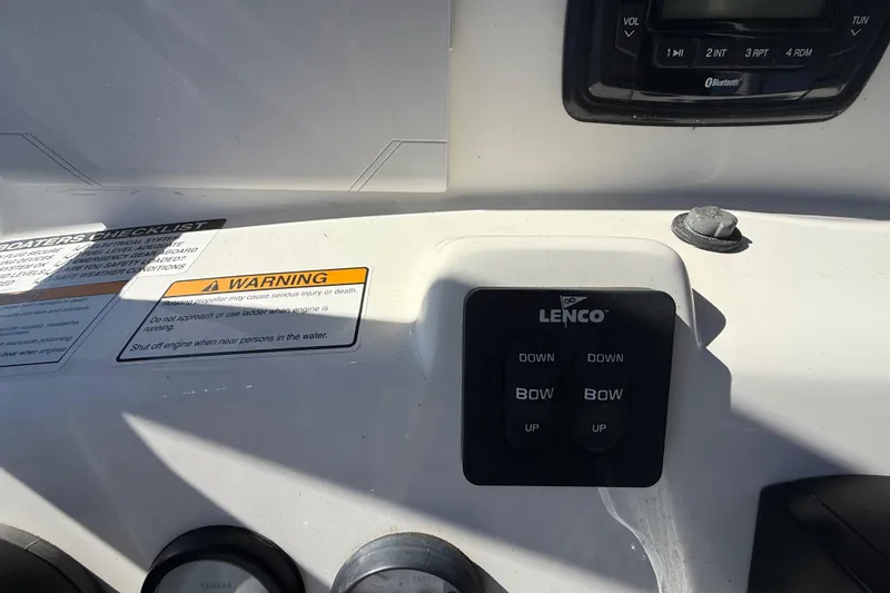 Slide: The Image of 2022 NauticStar 231 Hybrid boat dashboard with Lenco controls and warning labels. - 20