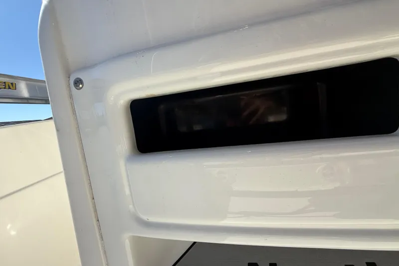 Slide: The Image of Close-up of 2022 NauticStar 231 Hybrid boat detail, featuring sleek white surface. - 24