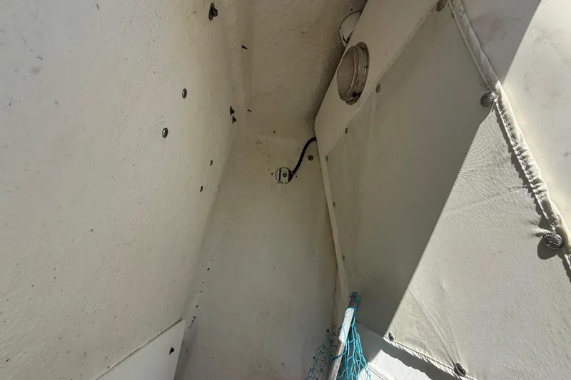 Slide: The Image of Interior view of 2022 NauticStar 231 Hybrid boat, showing storage area details. - 26