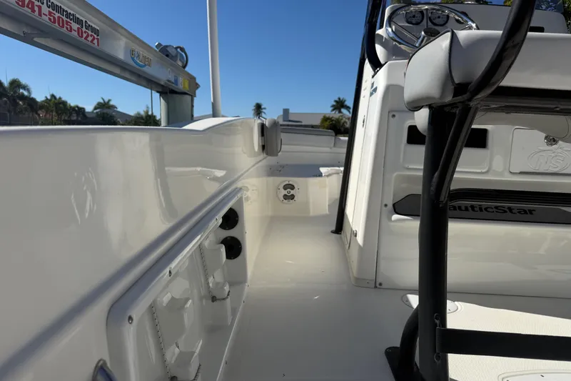 Slide: The Image of 2022 NauticStar 231 Hybrid boat interior with seating and control panel. - 27