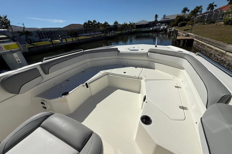 Slide: The Image of 2022 NauticStar 231 Hybrid boat interior with spacious seating and storage compartments. - 28