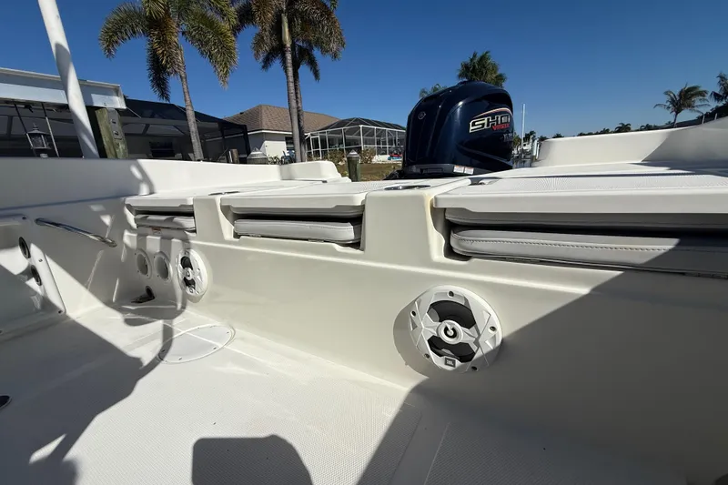 Slide: The Image of 2022 NauticStar 231 Hybrid boat interior with seating and speaker, under clear blue sky. - 40
