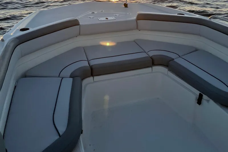 Slide: The Image of 2022 NauticStar 231 Hybrid boat interior with cushioned seating at sunset. - 42