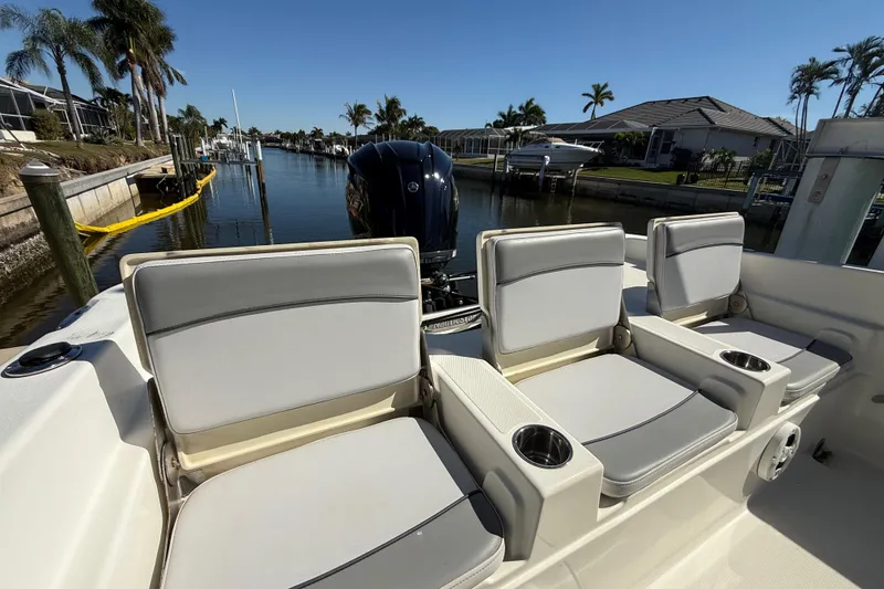 Slide: The Image of 2022 NauticStar 231 Hybrid boat interior with comfortable seating and cup holders. - 8