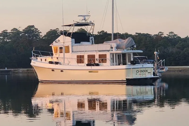 Slide: The Image of 2010 American Tug 49 Limited yacht on calm water at sunset. - 126
