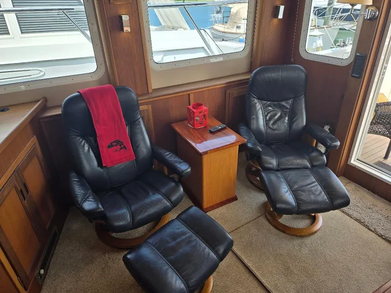 Slide: The Image of Luxurious 2010 American Tug 49 Limited interior with leather chairs and wooden accents. - 18