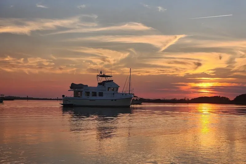 Slide: The Image of American Tug 49 Limited 2010 at sunset on tranquil water. - 2