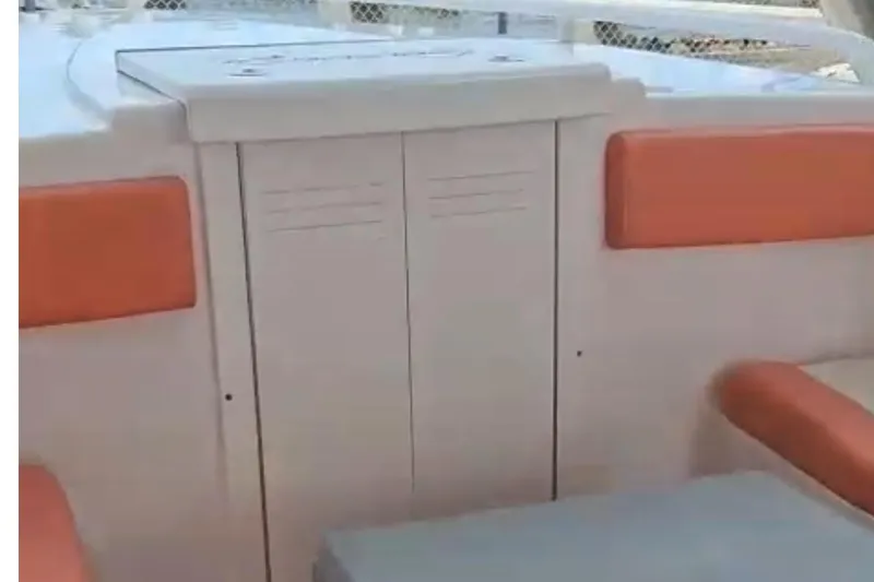 Slide: The Image of 2006 Renegade 32 Cuddy boat interior with orange seating and storage compartment. - 16