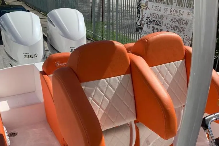 Slide: The Image of Orange and white seating on 2006 Renegade 32 Cuddy boat with Yamaha engines. - 18