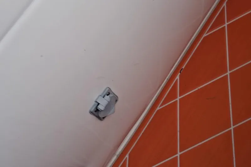 Slide: The Image of Interior detail of a 2006 Renegade 32 Cuddy boat with orange-tiled flooring. - 21