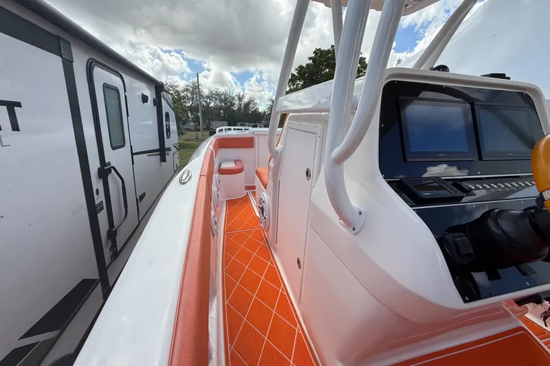 Slide: The Image of 2006 Renegade 32 Cuddy boat with orange interior and modern dashboard. - 24