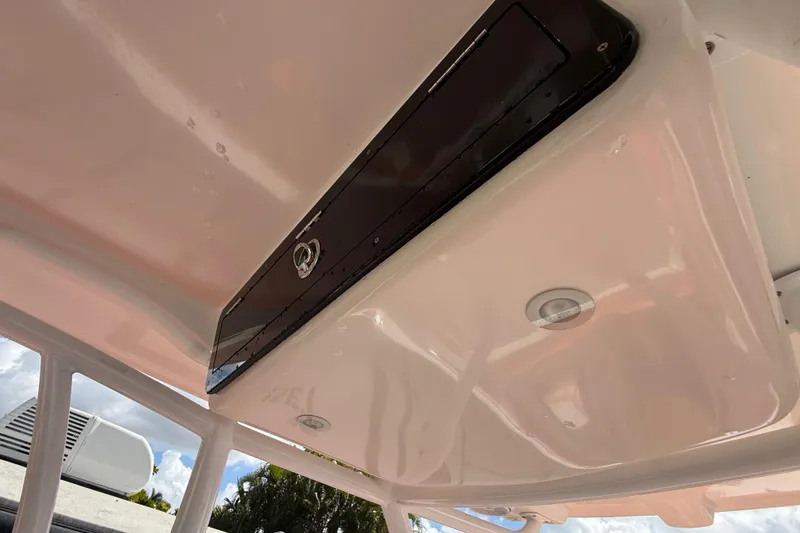Slide: The Image of 2006 Renegade 32 Cuddy boat interior ceiling with storage compartment and lighting. - 27