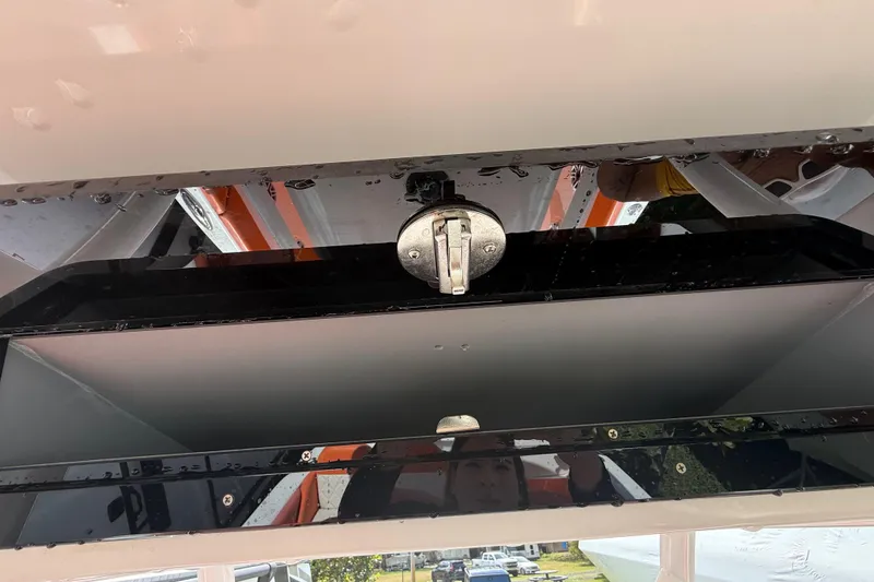 Slide: The Image of 2006 Renegade 32 Cuddy boat detail showing a storage compartment with latch. - 29