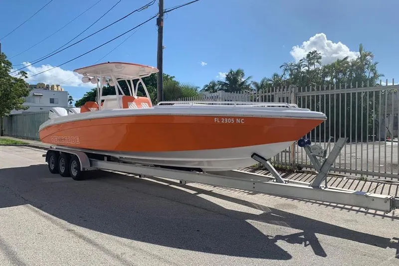 Slide: The Image of 2006 Renegade 32 Cuddy boat with dual Yamaha engines on a trailer. - 3