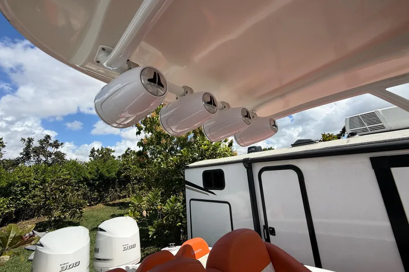 Slide: The Image of 2006 Renegade 32 Cuddy boat with JL Audio speakers and Yamaha engines, outdoors. - 31