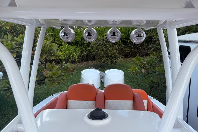 Slide: The Image of 2006 Renegade 32 Cuddy boat interior with orange seating and rod holders. - 40