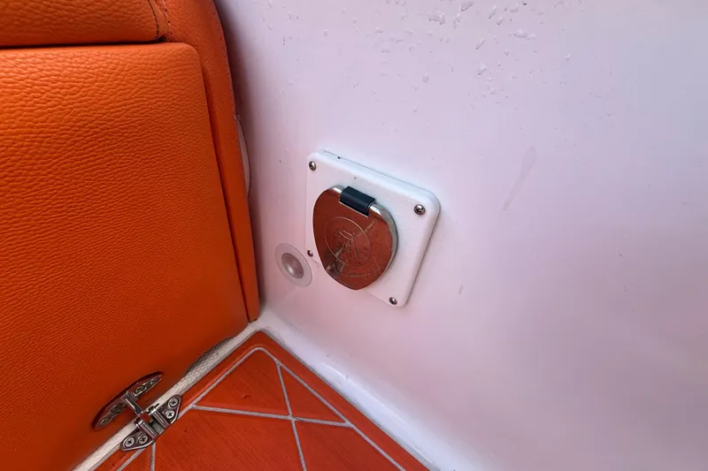 Slide: The Image of 2006 Renegade 32 Cuddy interior detail with orange upholstery and metal fixture. - 43