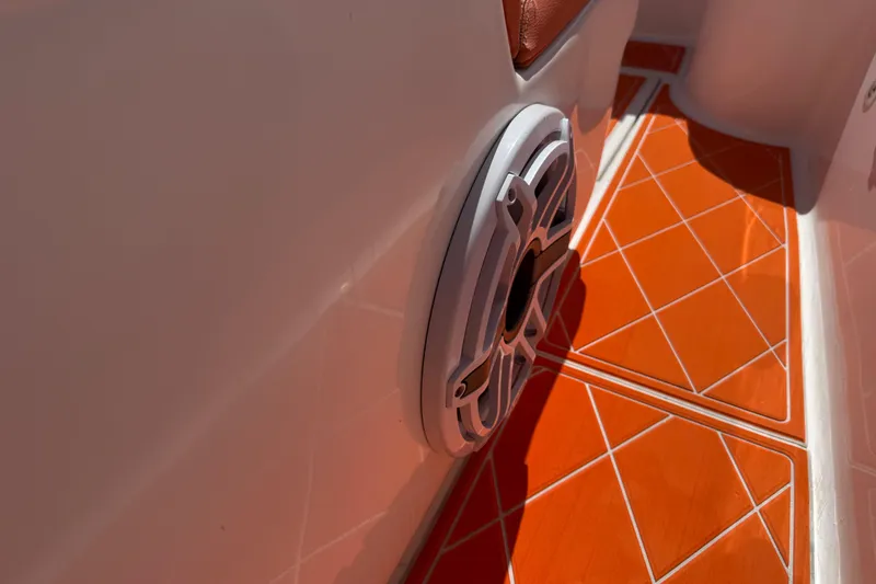 Slide: The Image of 2006 Renegade 32 Cuddy boat interior with orange flooring and speaker detail. - 46