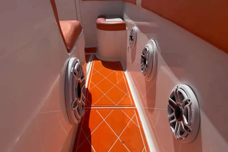 Slide: The Image of 2006 Renegade 32 Cuddy boat interior with orange flooring and built-in speakers. - 48