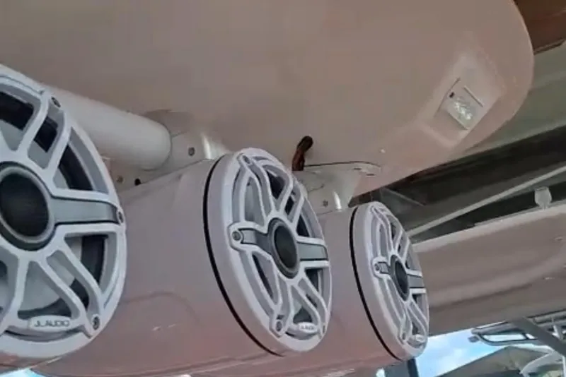 Slide: The Image of 2006 Renegade 32 Cuddy boat dashboard with dual navigation screens and wooden steering wheel. - 5