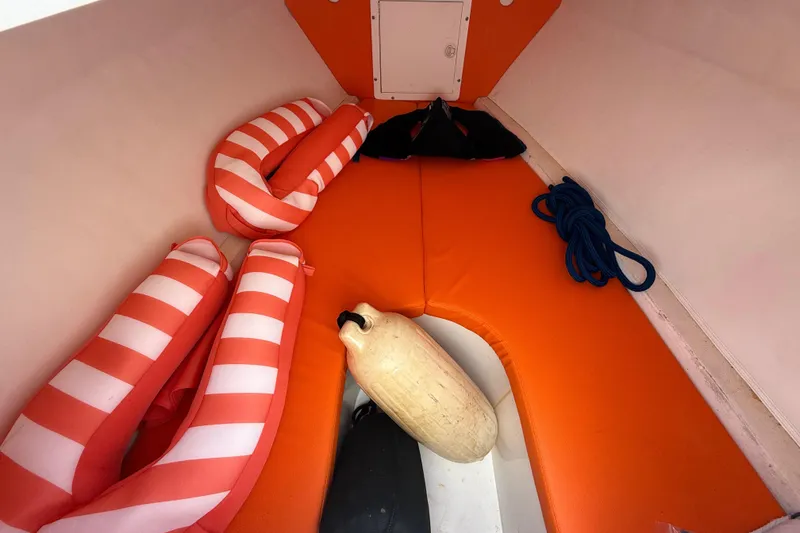 Slide: The Image of 2006 Renegade 32 Cuddy interior with life vests, rope, and buoy. - 52