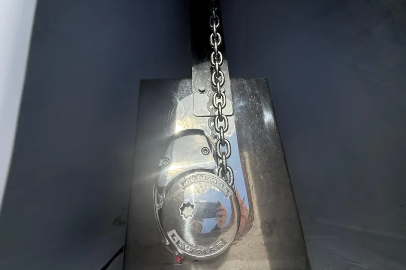 Slide: The Image of Anchor chain and winch on 2006 Renegade 32 Cuddy boat, reflecting sunlight. - 53