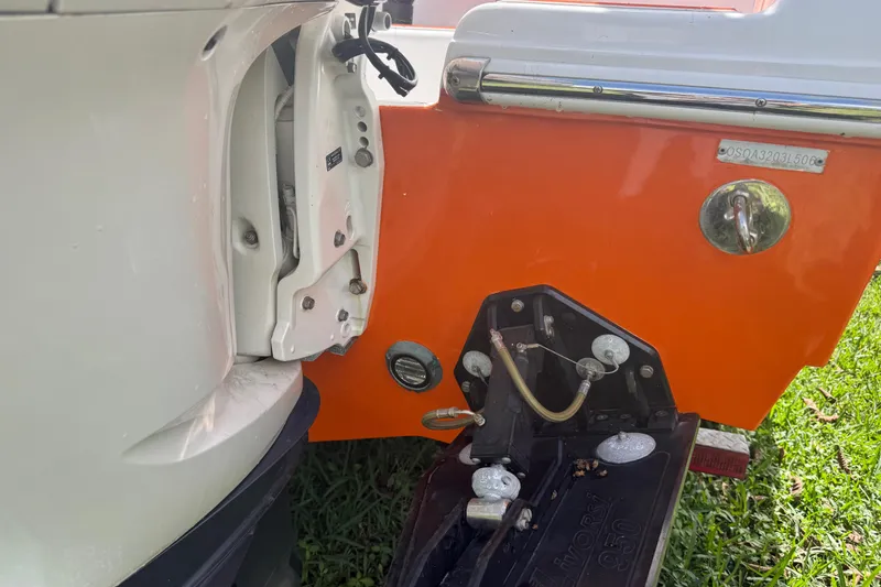 Slide: The Image of 2006 Renegade 32 Cuddy boat engine and transom detail, featuring vibrant orange hull. - 57