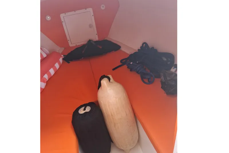 Slide: The Image of 2006 Renegade 32 Cuddy boat with orange and white seating, viewed from above. - 9