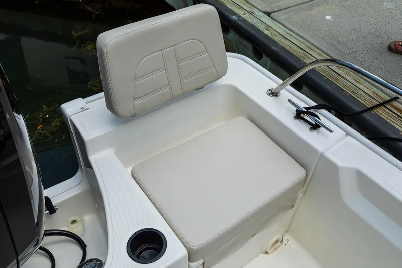 Slide: The Image of 2026 Boston Whaler 190 Montauk boat dashboard with steering wheel and navigation instruments. - 2