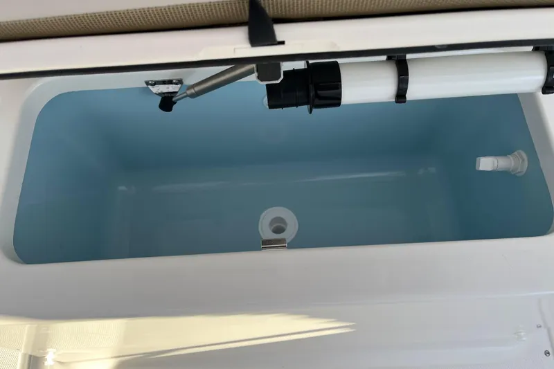 Slide: The Image of Livewell compartment in 2026 Boston Whaler 190 Montauk boat, featuring plumbing and drainage. - 9