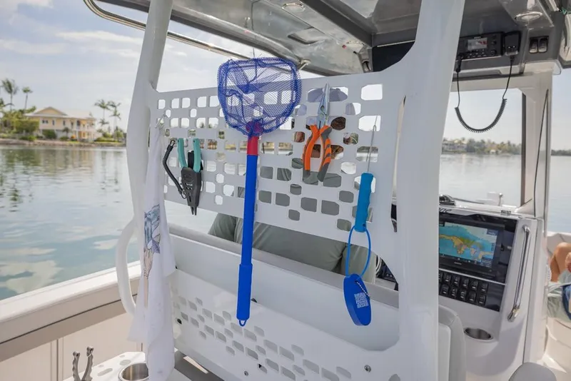 Slide: The Image of 2025 Hurricane Center Console 24 OB boat interior with fishing tools and equipment. - 10