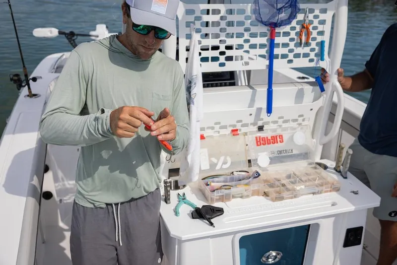 Slide: The Image of Man preparing fishing gear on 2025 Hurricane Center Console 24 OB boat. - 14