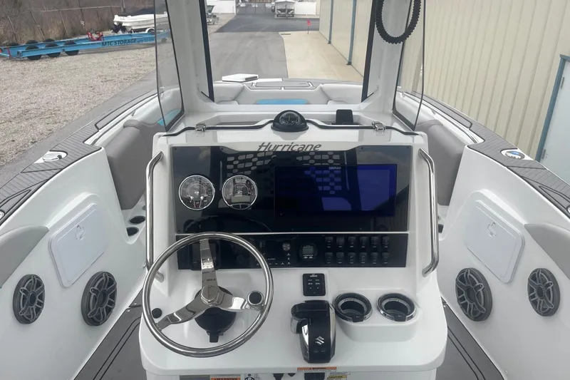 Slide: The Image of 2025 Hurricane Center Console 24 OB boat dashboard with steering wheel and controls. - 18