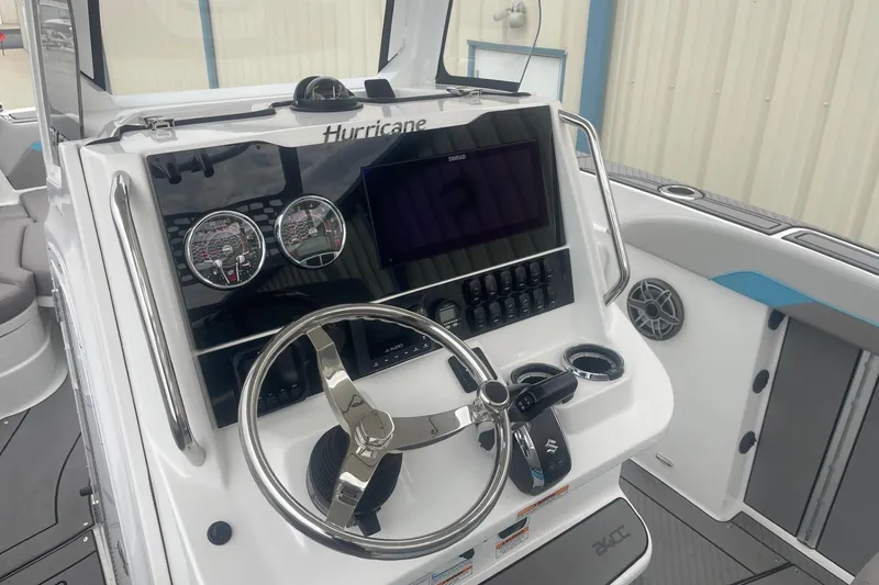 Slide: The Image of 2025 Hurricane Center Console 24 OB boat dashboard with steering wheel and controls. - 20