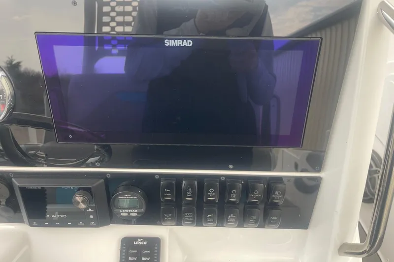 Slide: The Image of 2025 Hurricane Center Console 24 OB dashboard with Simrad display and control panel. - 22