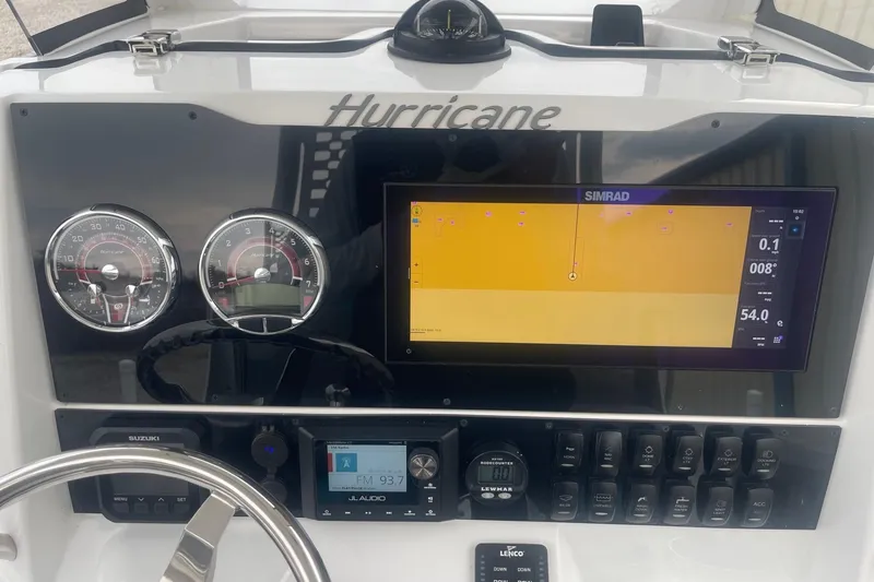 Slide: The Image of 2025 Hurricane Center Console 24 OB dashboard with Simrad display and gauges. - 24