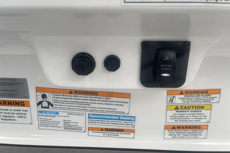 Slide: The Image of Control panel with warnings on a 2025 Hurricane Center Console 24 OB boat. - 25