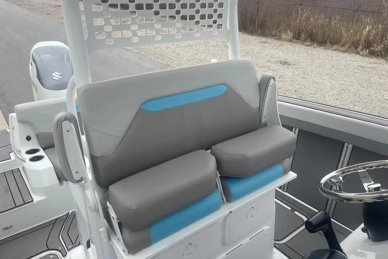 Slide: The Image of 2025 Hurricane Center Console 24 OB boat interior with cushioned seating and steering wheel. - 27