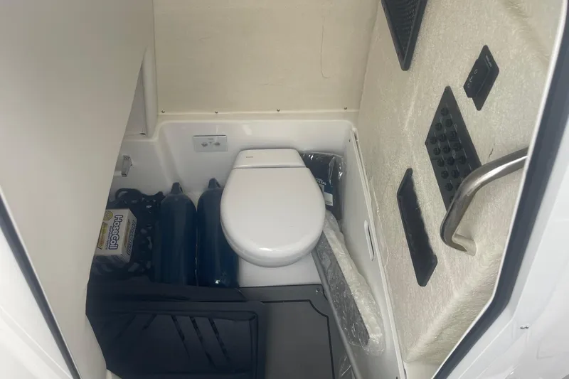 Slide: The Image of Interior of 2025 Hurricane Center Console 24 OB boat with compact marine toilet. - 34