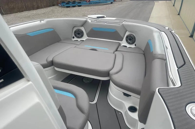 Slide: The Image of 2025 Hurricane Center Console 24 OB boat interior with gray seating and blue accents. - 36