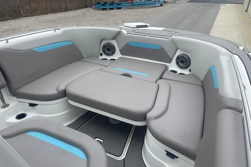 Slide: The Image of 2025 Hurricane Center Console 24 OB boat interior with gray seating and blue accents. - 37