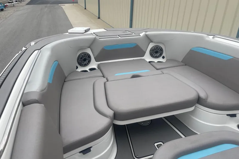 Slide: The Image of 2025 Hurricane Center Console 24 OB boat interior with gray seating and blue accents. - 38